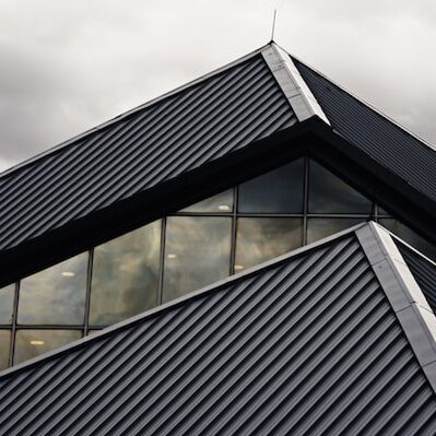 gray and black building under white clouds